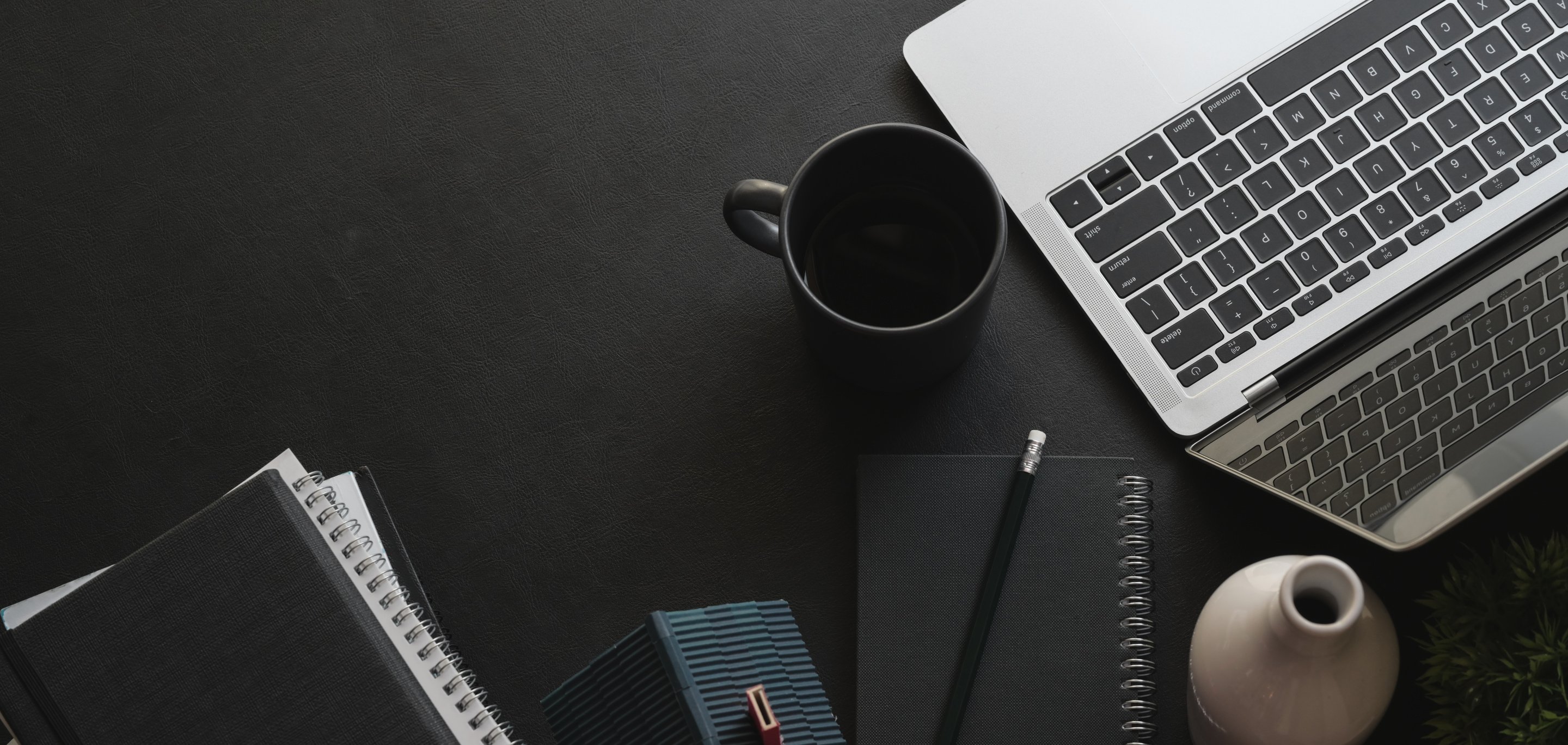 laptops, notebooks, and other office supplies on a desk